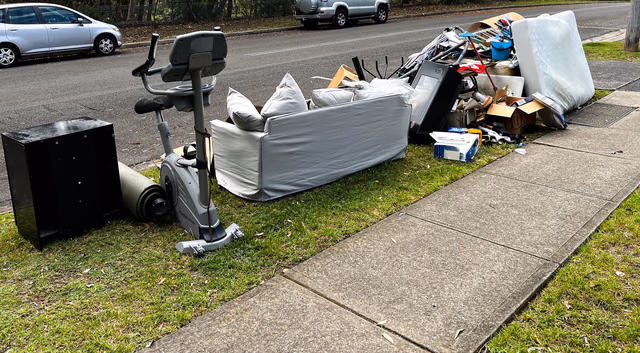 Curbside pile of furniture and household junk ready for haul-away